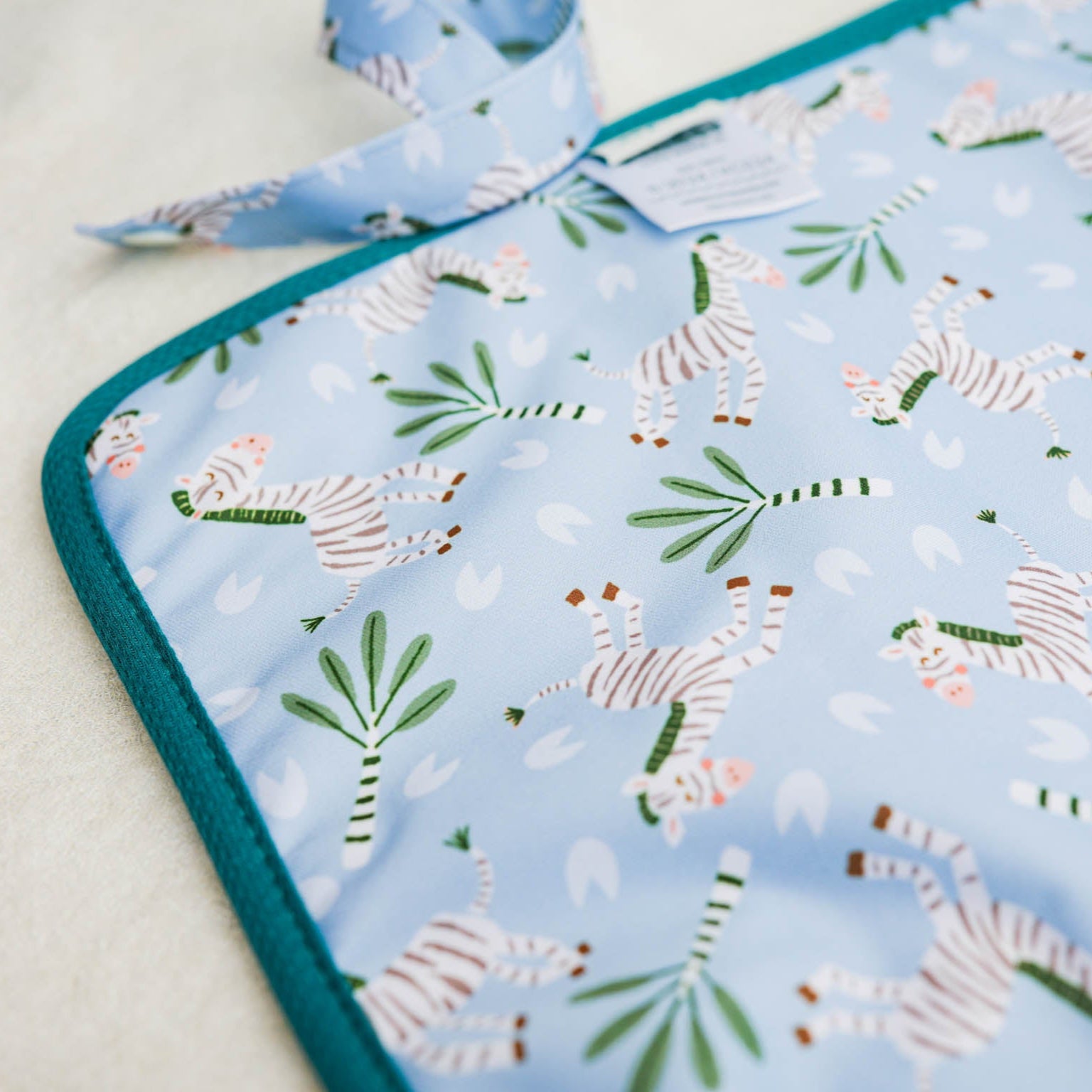 Baby blanket with zebra pattern on a light blue background