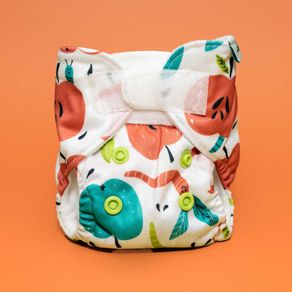 pretend play reusable doll baby diapers fits most dolls and stuffies machine washable cloth diaper apples worms whimsical playful print