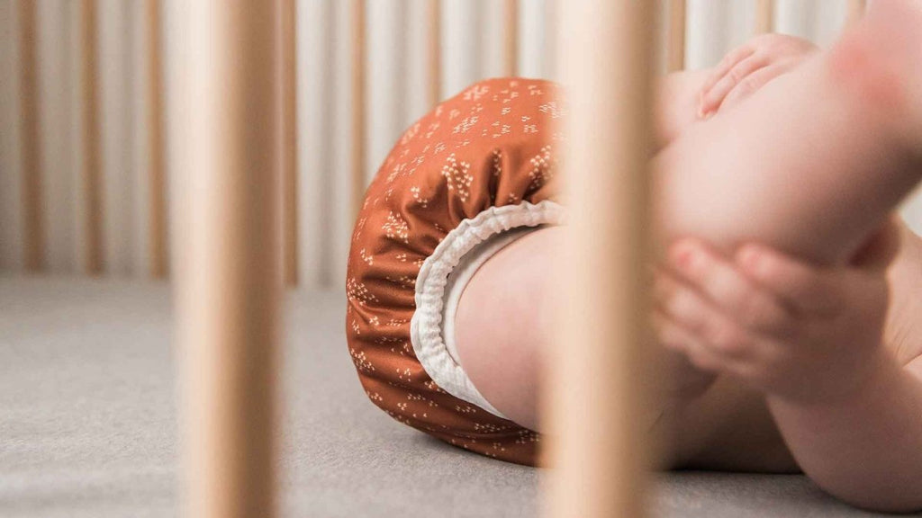 Baby wearing reusable cloth diaper cover best overnight cloth diapering solutions for a leak free fit