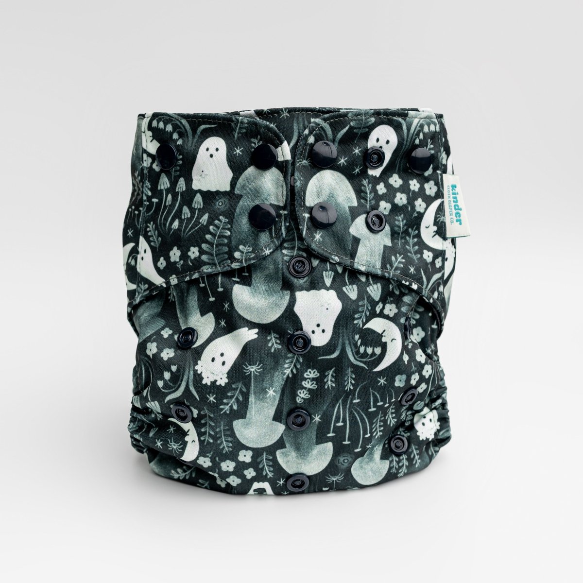 black cloth diaper with whimsical ghosts in the garden with black snaps by kinder cloth diaper co with art by Malika Buttinger, one size fits most