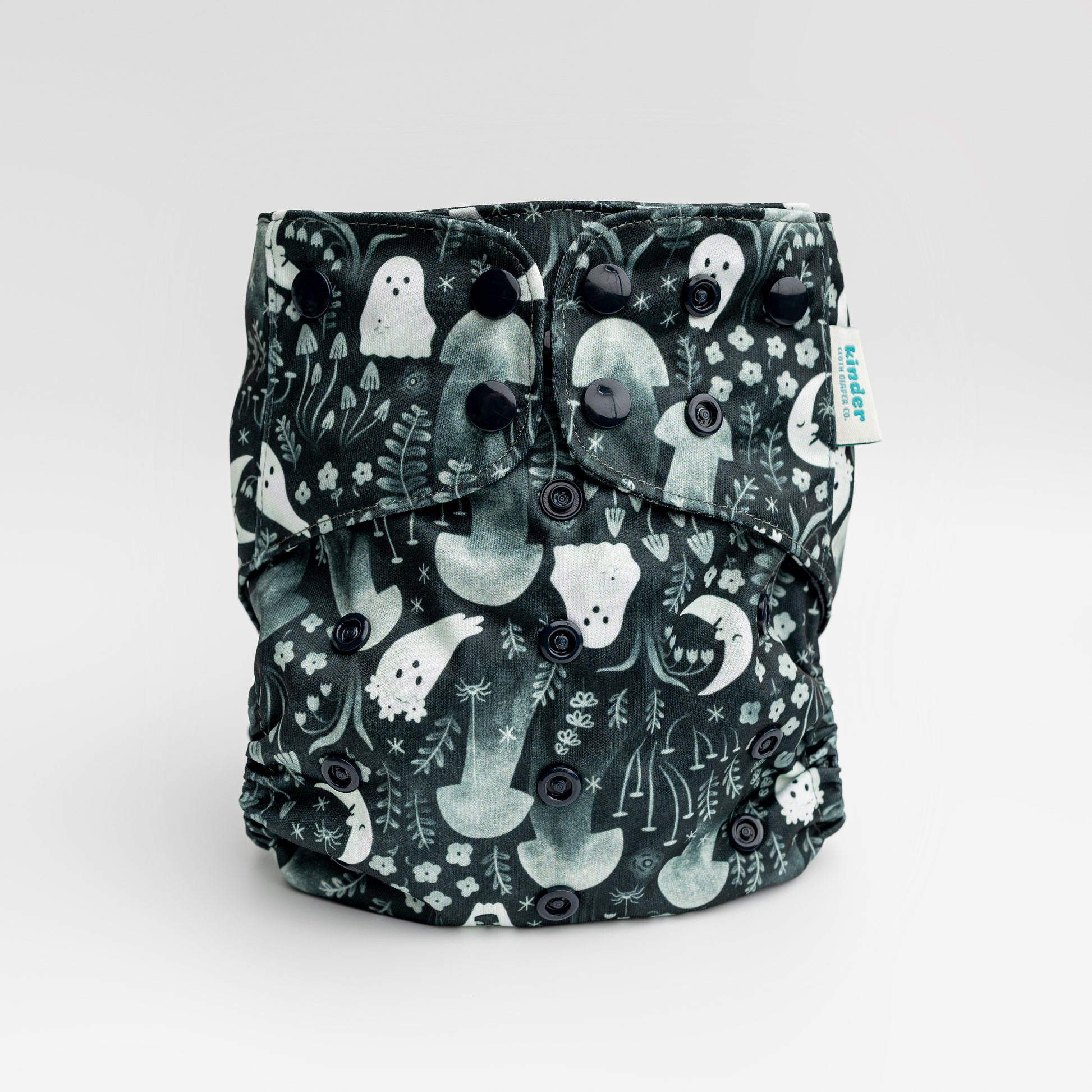 black cloth diaper with whimsical ghosts in the garden with black snaps by kinder cloth diaper co with art by Malika Buttinger, one size fits most