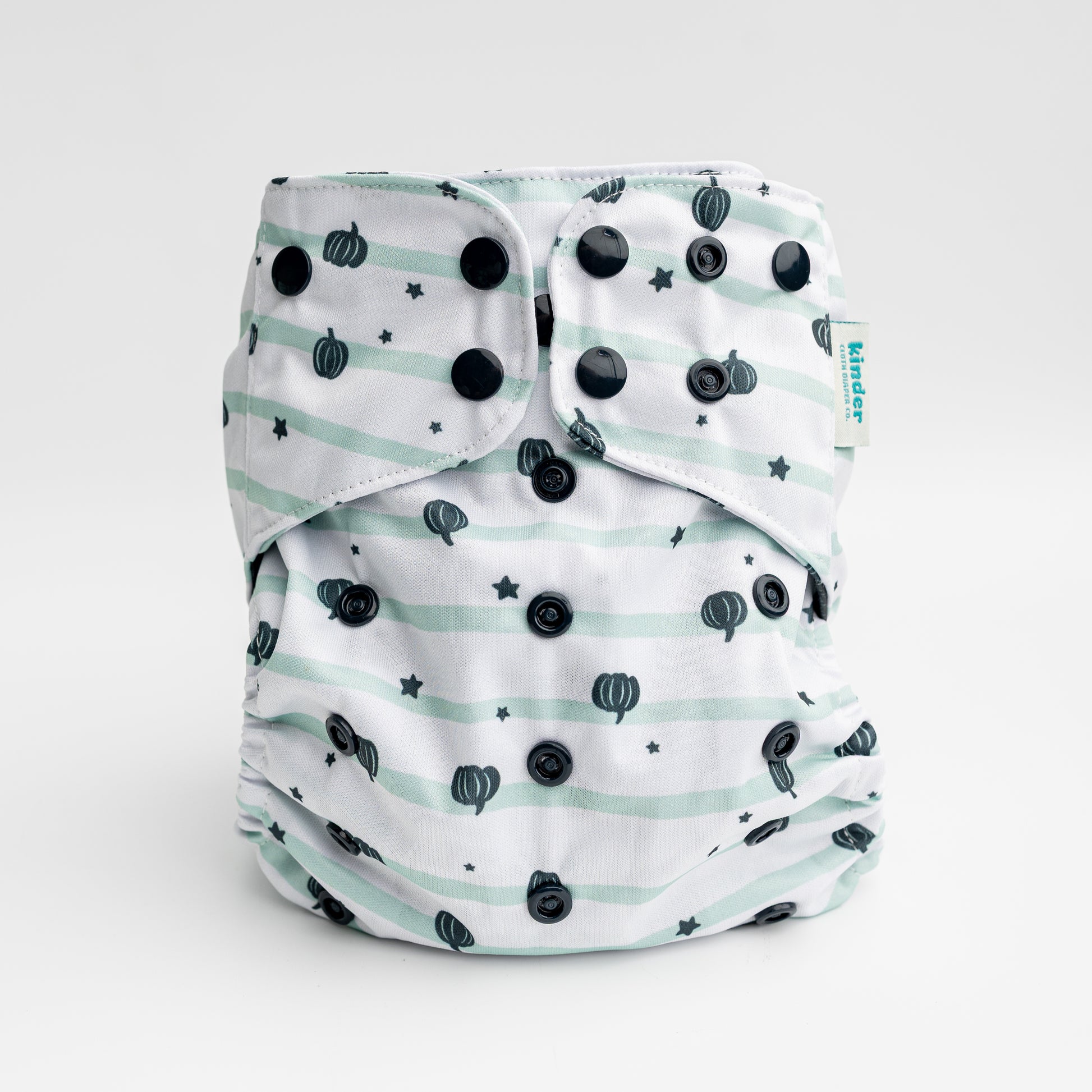 a five star white pocket diaper with tiny green pumpkins black snaps by kinder cloth diaper co, one size fits most