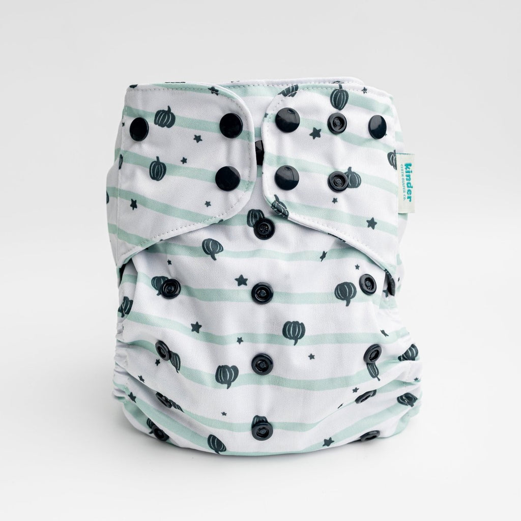 a five star white pocket diaper with tiny green pumpkins black snaps by kinder cloth diaper co, one size fits most